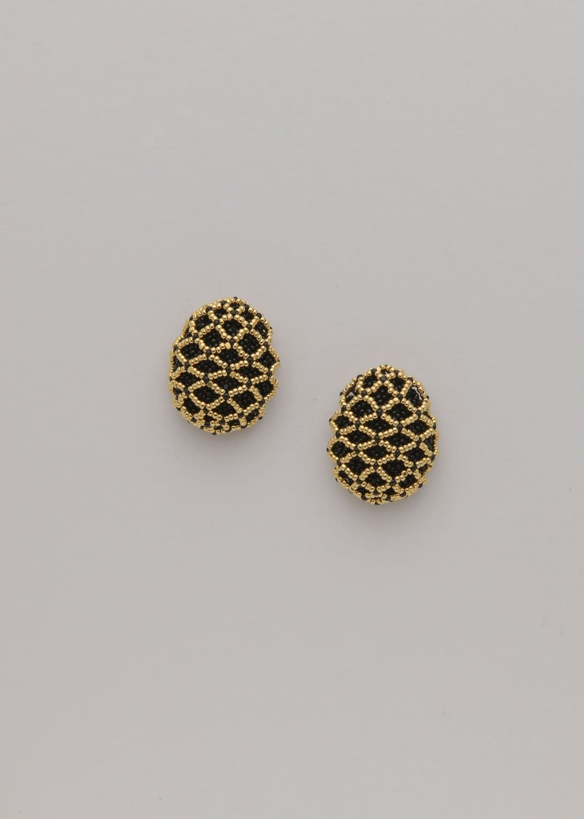 BROQUELES TEJIDO ABIERTO TAWARI ORO NEGRO