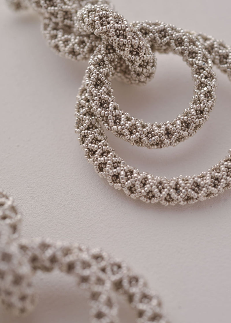 ARETES CINCO AROS NAWI PLATA PLATINO