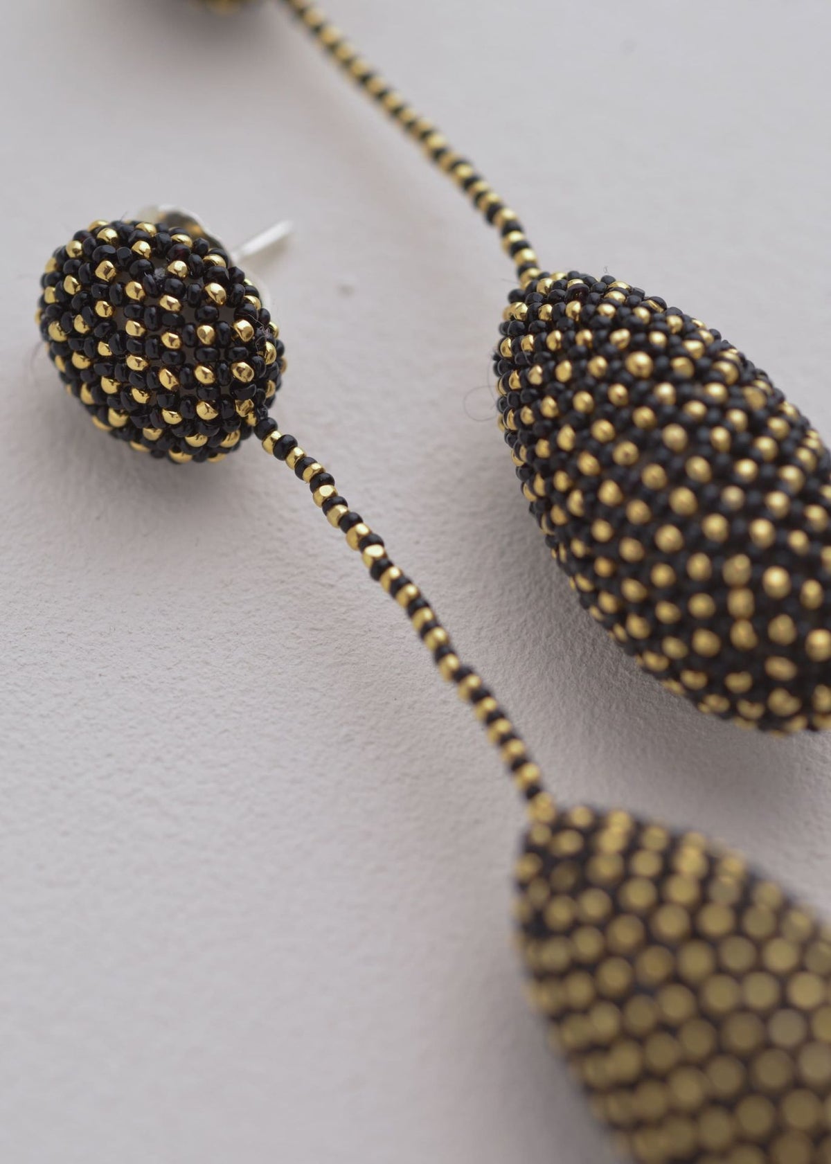 ARETES COLGANTES TAWARI ORO NEGRO